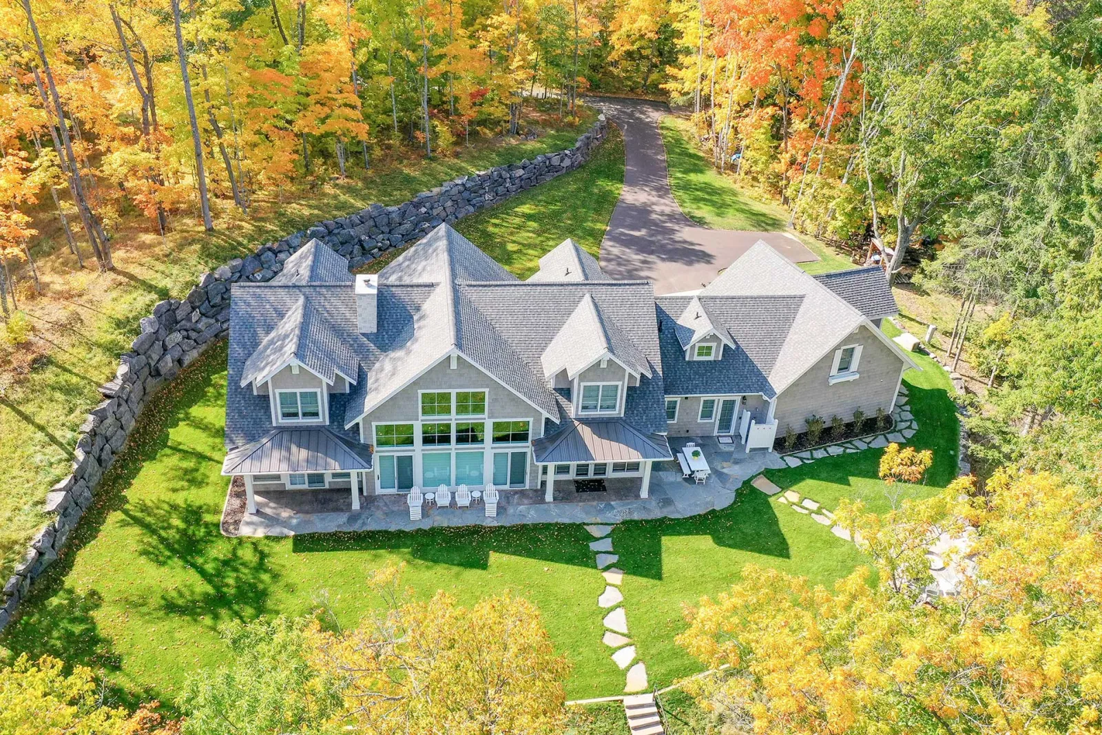 Aerial photograph of a custom home with a broad deck among trees, from the Nelson Lumber project gallery.